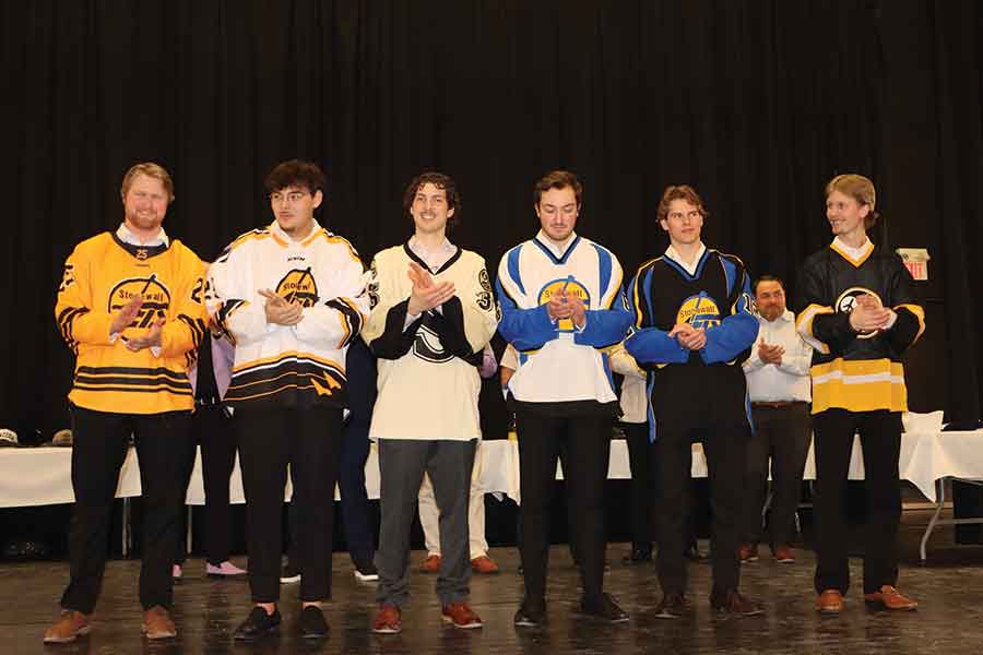 Graduating Stonewall Jets players, left to right, Karson King, Cohen Cheung, Austin Lorenco, Brody Stovin, Peyton Bateman and Alex Kaczorowski model several jerseys worn throughout the team’s history while unveiling the club’s new commemorative jersey celebrating 25 years in the Manitoba Major Junior Hockey League during the Jets’ annual gala Saturday evening at the Quarry Park Heritage Arts Centre