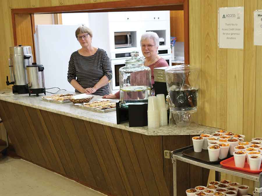 Volunteers Colleen Cook (left) and Judy Nickel kept guests well supplied with refreshments and snacks during the Moosehorn Community Club’s March 14 fundraising event at the Moosehorn Centennial Hall