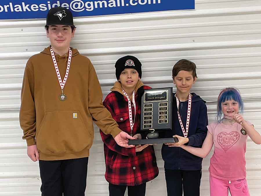 Payton Malfait, Cameron Jessup, Seeley Burke and Gabrielle Rawdon celebrate their win at the Marquette Curling Club youth bonspiel on March 14