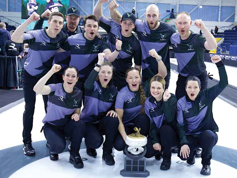 Members of Shield Curling Club — Brad Jacobs, Benoît Schwarz-van Berkel, Jacob Horgan, Dan Marsh, Mattia Giovanella, Amos Mosaner, Kerri Einarson, Tracy Fleury, Agnes Knochenhauer, Marlee Powers and Carole Howald — celebrate with the championship trophy after winning the inaugural Rock League title in Toronto