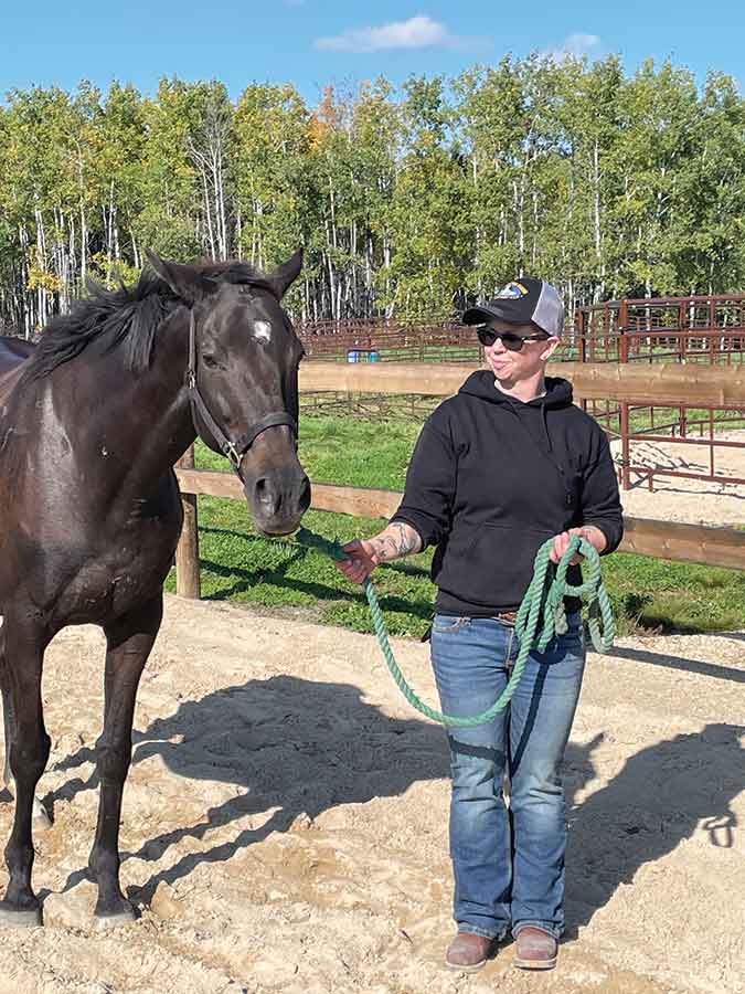Stonewall resident Becky Lemon, a 2023 R3VHC participant and current volunteer, is pictured with Melody. Lemon says attending the camp helped her regain confidence and a renewed sense of purpose