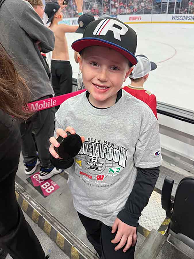 Owen, grandson of Don Deprez, was all smiles after a player tossed him a puck over the boards during the championship weekend in Las Vegas