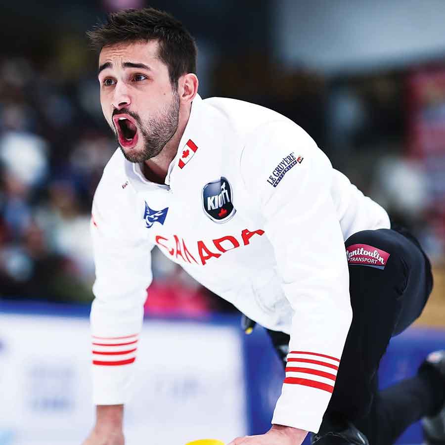 Colton Lott urges his teammates to sweep hard while delivering a shot for Canada