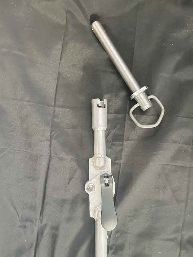 The Drawhand is a handheld extendable tool that allows an operator to insert a hitch pin from the cab of a tractor