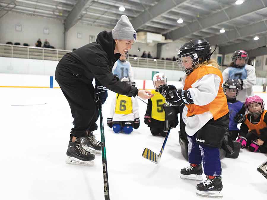 Coach Jadyn presents Charolotte Scrivens with the U7 Sprite Award