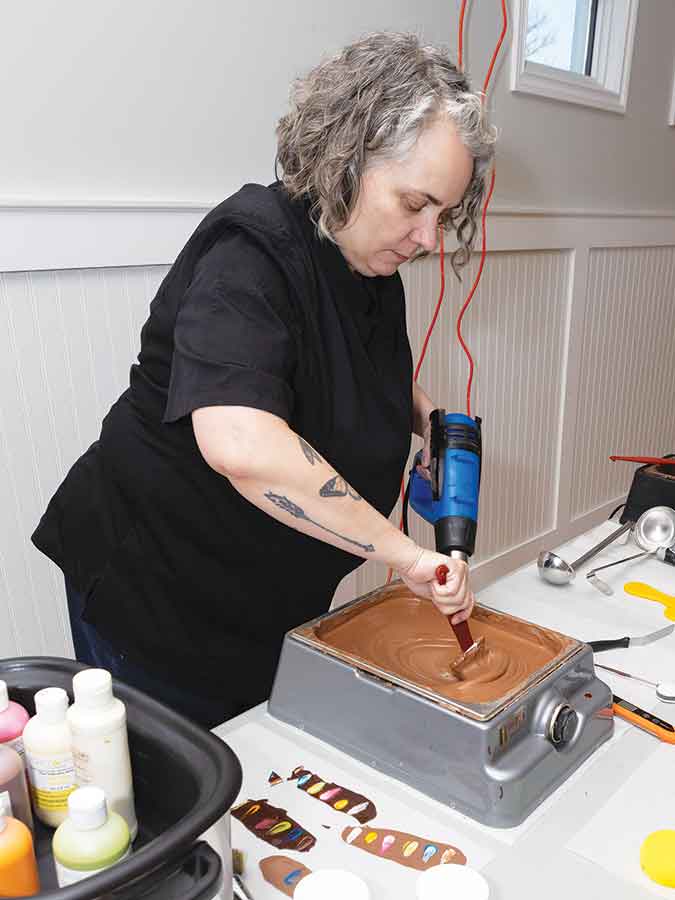 Chocolatier Rachel McKinley stirs milk chocolate, carefully maintaining a temperature between 31 and 33 C