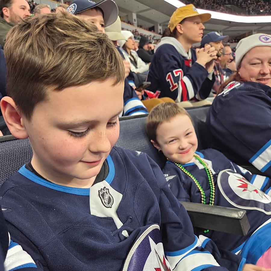 Childhood cancer survivors Kwintyn Dziedzic and Abigail Snyder attend a Winnipeg Jets game courtesy of The Dream Factory