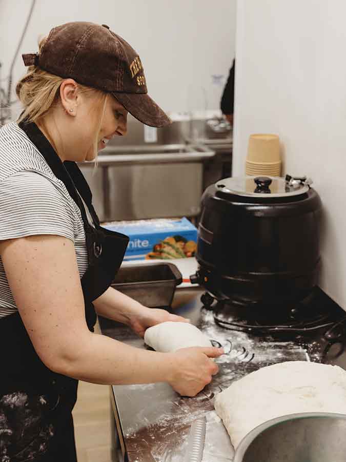 Tiffany Monkman prepares her best-selling sourdough loaves. She bakes her bread daily, ensuring she serves her customers the freshest products