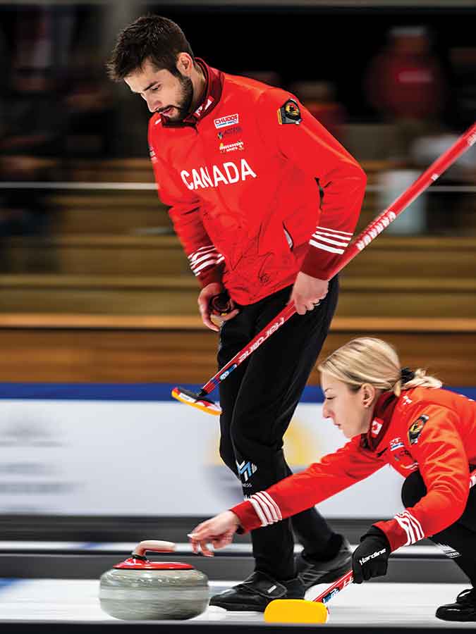 Kadriana Lott delivers a stone while Colton Lott prepares to sweep during mixed doubles action at the 2026 ACE & Company World Mixed Doubles Curling Championship, where the Gimli duo captured the bronze medal for Canada