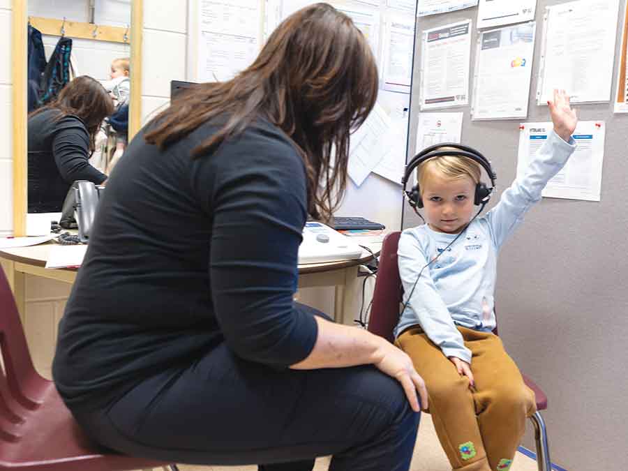 Morgan Wilson has her hearing tested by audiologist assistant Jodi Woods