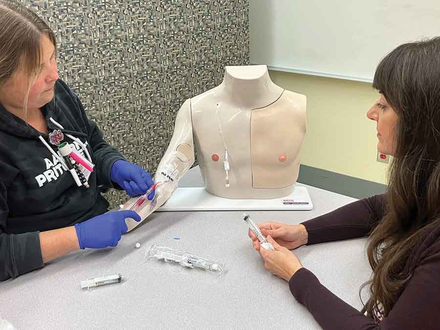 IERHA staff practice IV insertion using a “Chester Chest” training mannequin, part of expanded hands-on clinical education supported by a $10,000 donation from RBC and the RBC Foundation