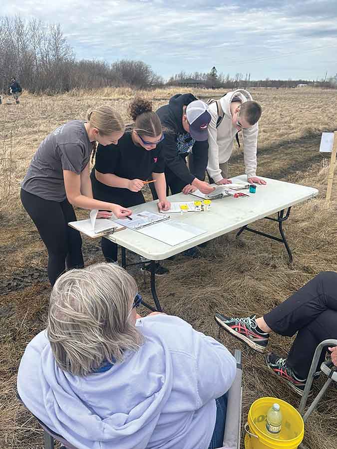 Warren Collegiate students are looking at water samples and identifying the chemical components such as pH and phosphorous content