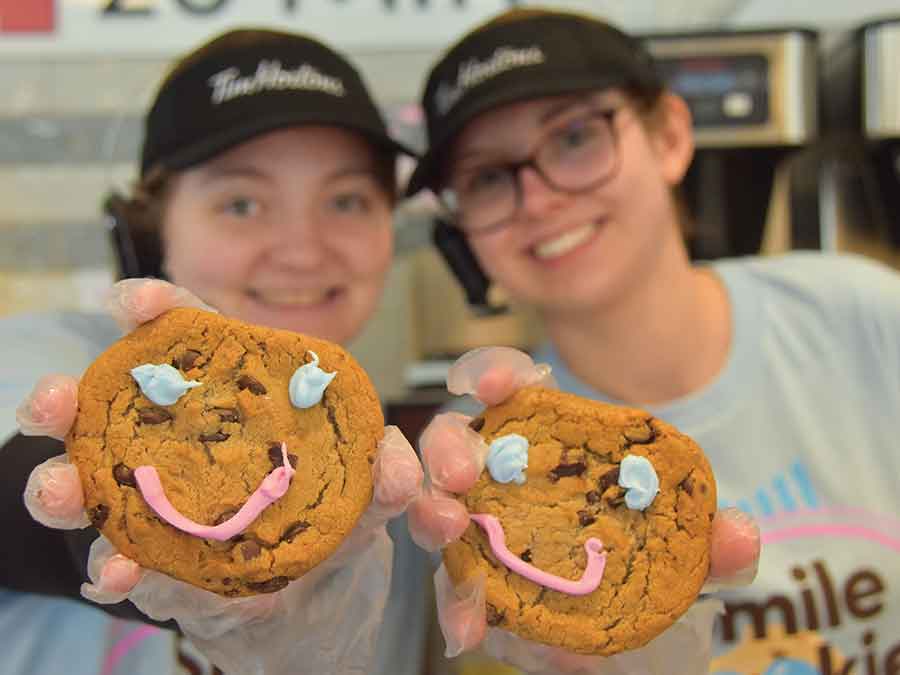 Staff with a couple of Smile Cookies