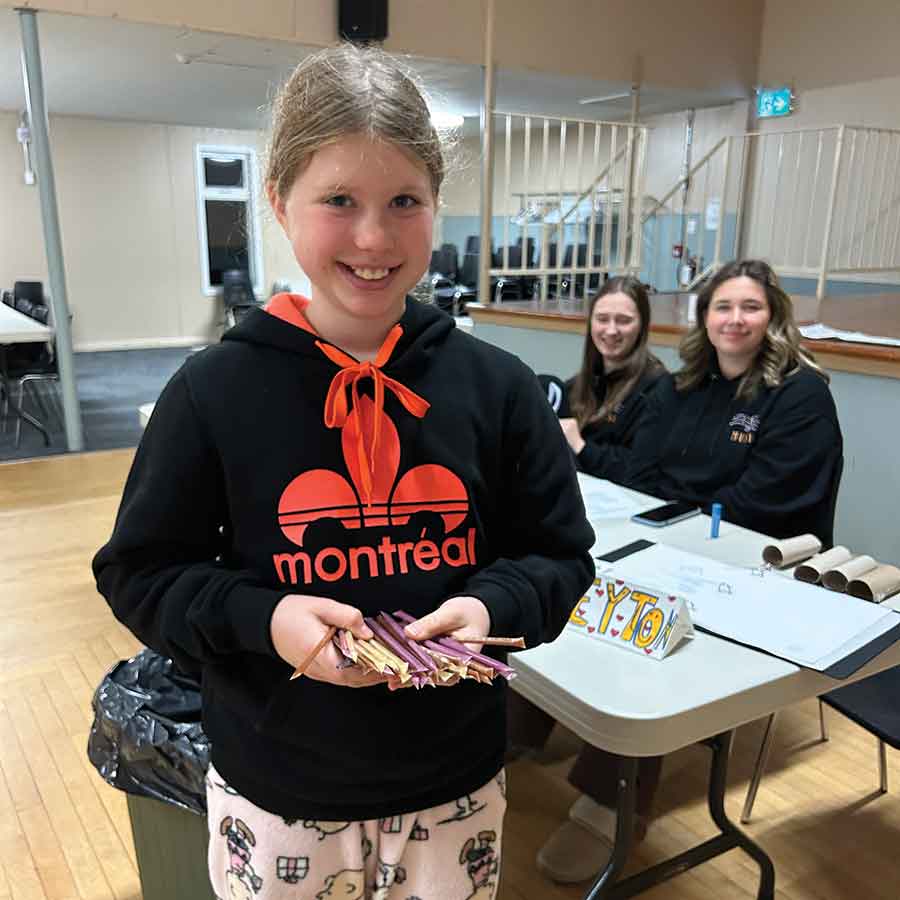 Peyton Marohn hands out flavoured honey sticks