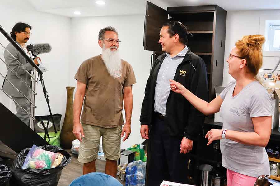 Manitoba Premier Wab Kinew speaks with Stonewall residents Paul and Holly Mulvihill during a tour of flood-damaged properties on June 11. The couple reported more than 12 inches of water in their basement following the record rainfall that struck the community earlier in the week