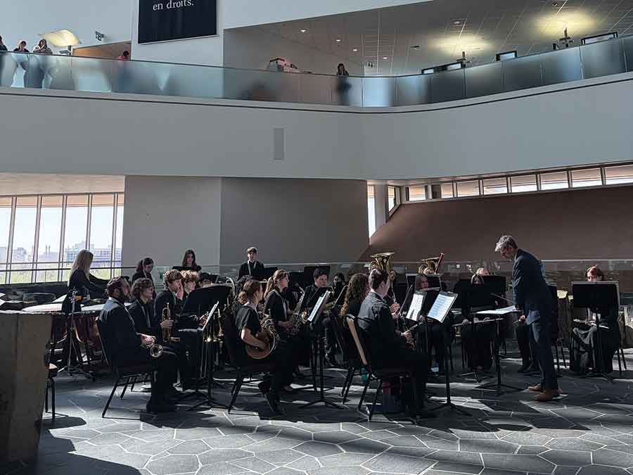 The Comp’s Senior Symphonic Band performs “We Are One” at the Canadian Museum for Human Rights. Anderson is the first student standing from the right