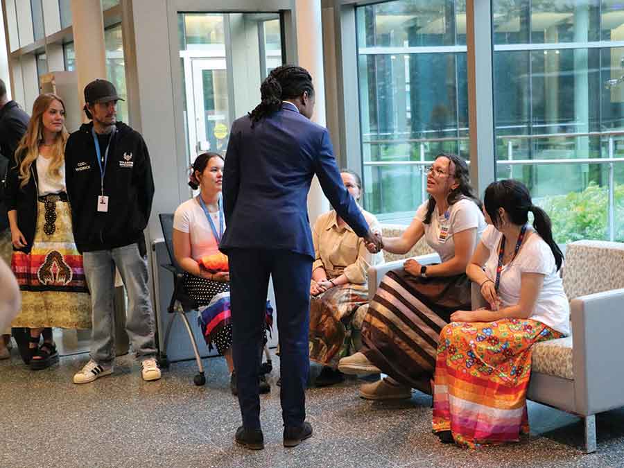 Health, Seniors and Long-Term Care Minister Uzoma Asagwara speaks with health-care staff at Selkirk Regional Health Centre