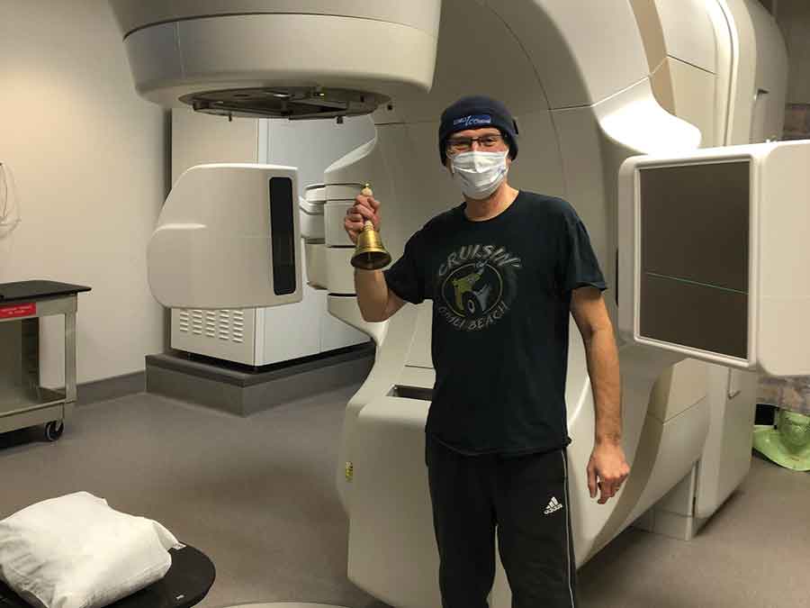 Peter Holfeuer underwent 32 radiation therapy sessions at CancerCare in Winnipeg. Holfeuer is holding a bell that patients get to ring when they finish radiation therapy. He had his last treatment in March 2022