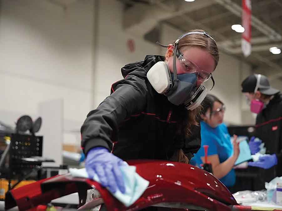 Cassandra Foy prepares a bumper for painting during her autobody collision repair training