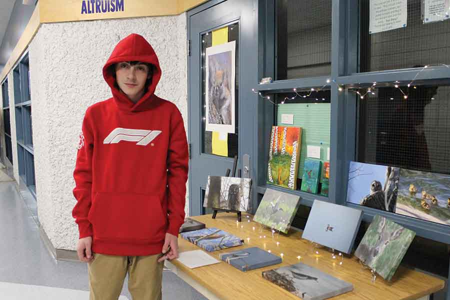 Dylan Labossiere with some of his wildlife photos on display