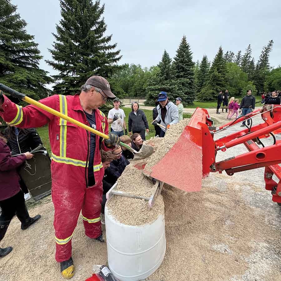 Hundreds of volunteers gathered in Stonewall on June 12 to fill and place sandbags in an effort to protect homes and properties threatened by rising floodwaters following the historic rainfall event