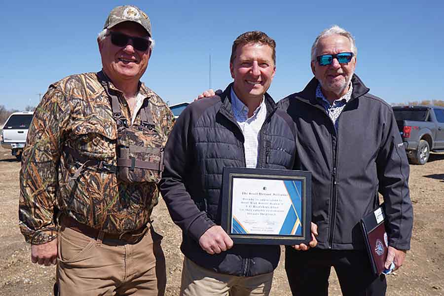 Randy Woroniuk (left) and Tim Arnason (right) presenting Tony Michaluk with a certificate of appreciation