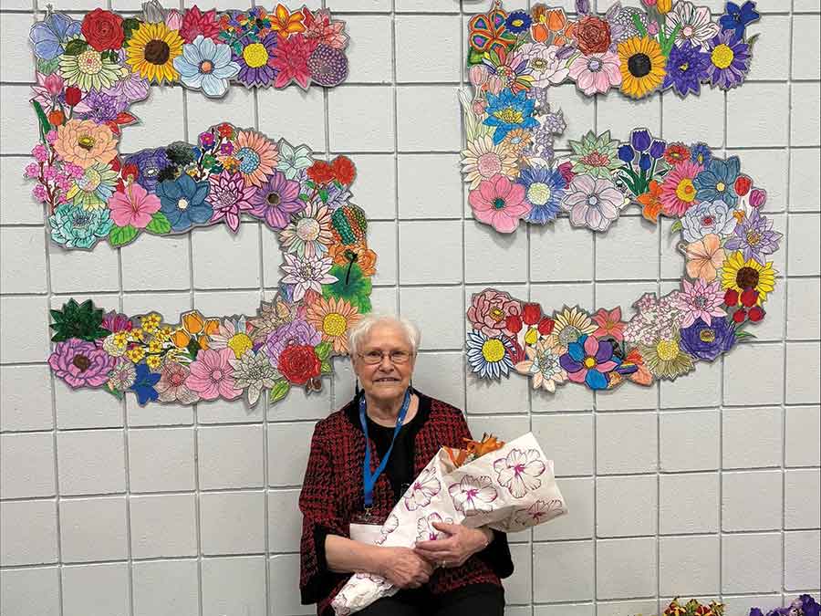 June Huska, the only surviving child of Alf Cuthbert, holds a bouquet of flowers presented to her during the afternoon program