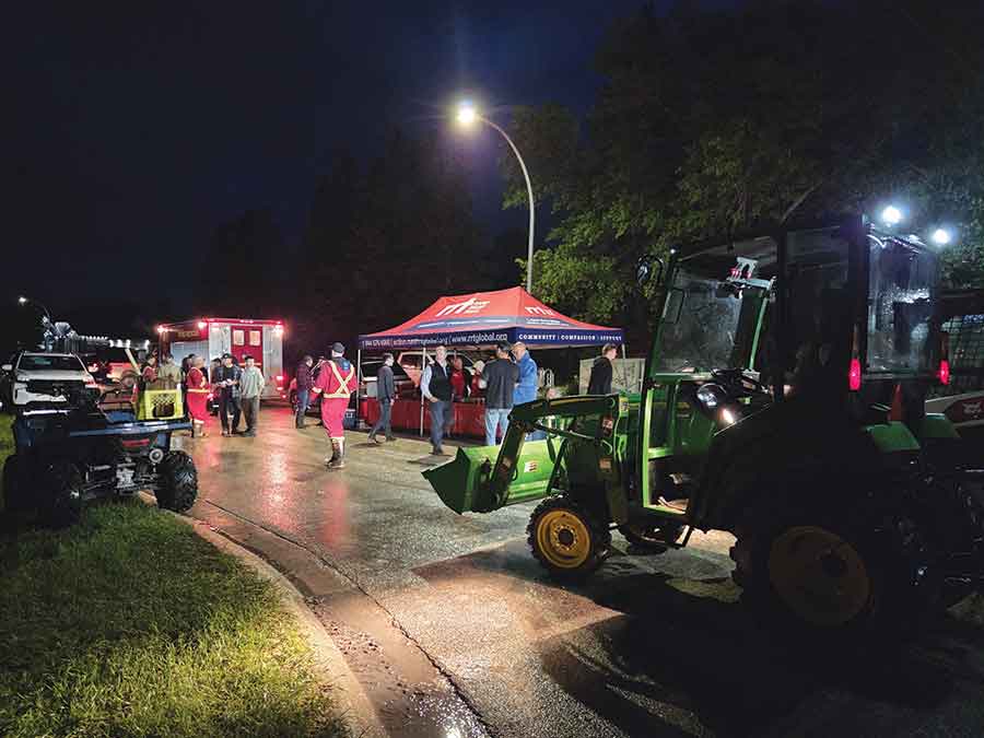 Members of the Rapid Relief Team served food and drinks to volunteers and residents during Stonewall’s June 12 sandbagging effort, while also providing care packages and practical support to flood-affected families