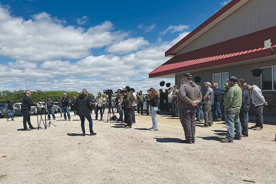 Progressive Conservative MLA and Municipal and Northern Relations critic Trevor King speaks to farmers, municipal leaders and residents gathered at Boonstra Farms