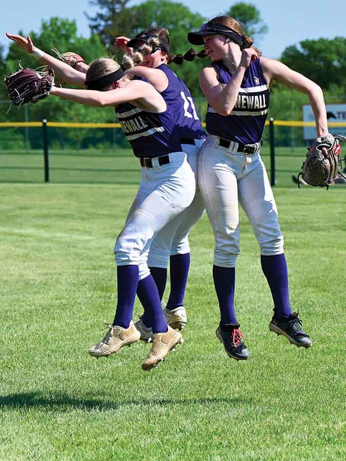 Lucy Hoff, Katie Braid and Peyton Rinn celebrate a play