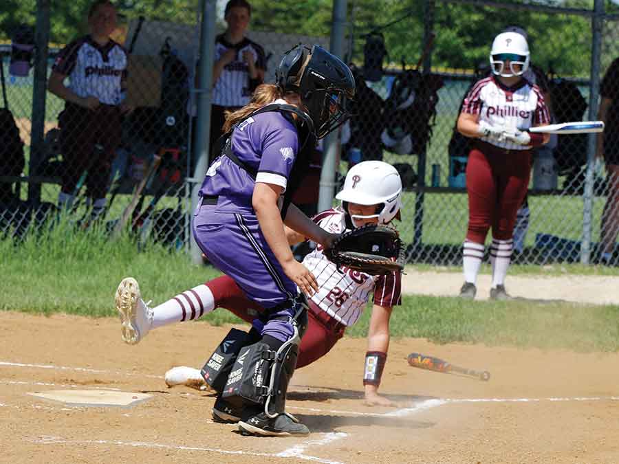 Interlake Phillies player Tayah William slides safely across home plate during Manitoba Premier AAA Softball League action against Central Energy on June 6 at Quarry Park in Stonewall