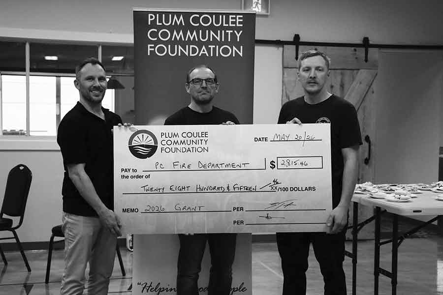 Taylor presents Plum Coulee Fire Department reps Tony Fehr and Riley Fehr with funds to purchase new wildland equipment