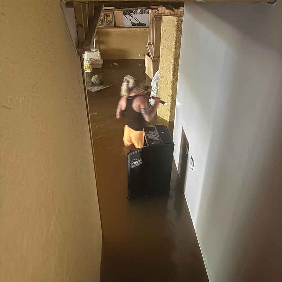 Gabby Smith-Landry stands in the flooded basement of her Winfield Road home, where nearly three feet of water caused extensive damage following the historic June 9-10 rainfall