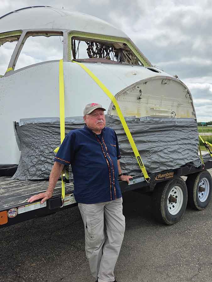 Captain Bob Pearson greets the Gimli Glider cockpit after its return to Canada