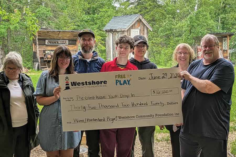 Representatives of the WCF present a $32,220 Free to Play grant to the Gimli Wave Youth Drop-In. Pictured, Mavis Lewis-Webber, Romanna Klymkiw, Jamie Vann (President, Hinterland Nature Camp), Jori Vann, Balam, Dr. Audrey Swift ( administrative head of the Wave Youth Drop-In), and Rick Wattling (treasurer, the Wave)